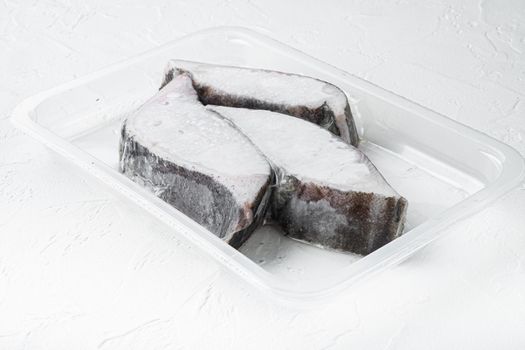 Raw fillets frozen halibut airtight vacuum pack set, on white stone table background
