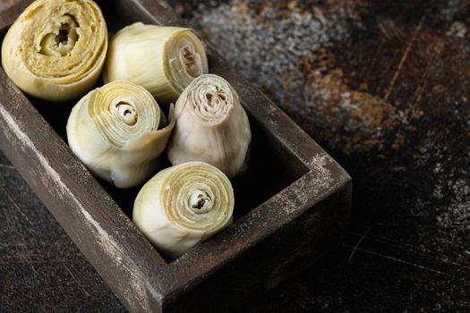 Artichoke hearts set, on old rustic background with space for text