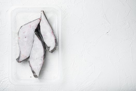 Halibut fish frozen steak pack set, on white stone table background, top view flat lay, with copy space for text