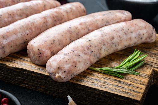 Chicken sausages, on black background.