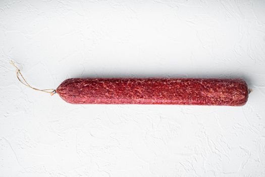 Delicious salami sausage set, on white stone background, top view flat lay, with copy space for text
