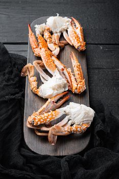 Boiled blue swimming crab parts set, on black wooden table background