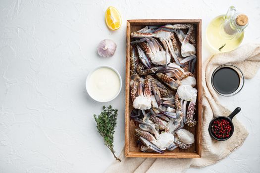 Fresh blue swimming crab parts set, in wooden box, on white background, top view flat lay , with copyspace and space for text