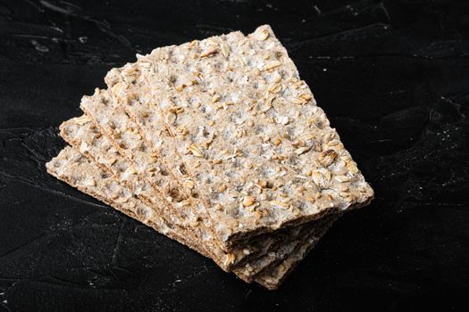 Crunchy crispbread Healthy snack set, on black dark stone table background
