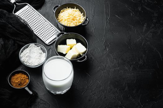 Preparation of bechamel cheese white sauce set, on black stone background, with copy space for text