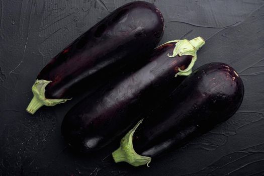 Eggplant, aubergine organic ripe whole vegetables set, on black stone background, top view flat lay