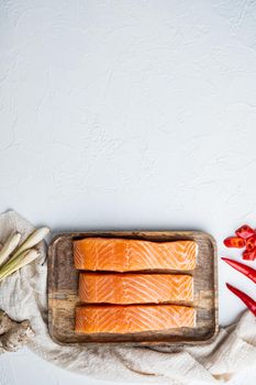 Raw trout with herb, on white textured background, flat lay with space for text
