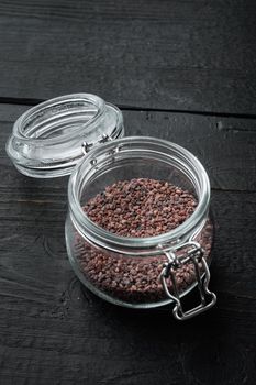 Indian Black salt, Kala namak hindi Healthy food concept set, in glass jar, on black wooden background