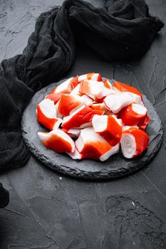 Fresh Crab meat surimi with blue swimming crab set, on stone board, on black background