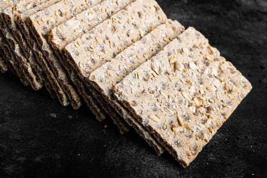 Set of crispy breads set, on black dark stone table background