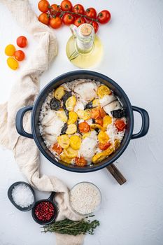 One pan fabulous fish, with basmati rice and cherry tomatoes, on white background, top view