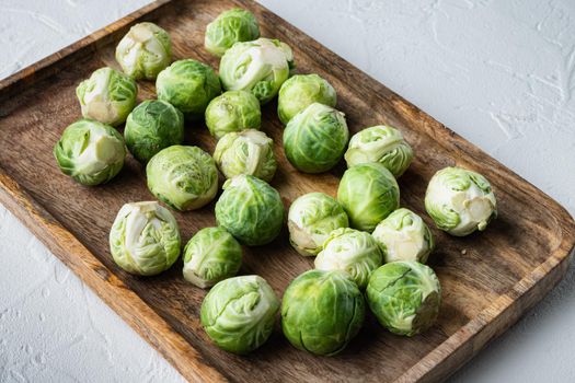 Raw brussels sprouts, on white textured background
