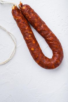 Spanish chorizo sausage on white background with space for text.