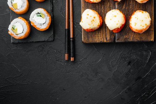 Sushi roll, Philadelphia with salmon, smoked eel, avocado, cream cheese set, on black stone background, top view flat lay , with copyspace and space for text