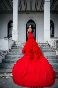 Woman Vintage Red Dress Old Castle Beautiful Princess In Seductive Dress Elegant Caucasian Female Fairy Tale story Dark Stairs