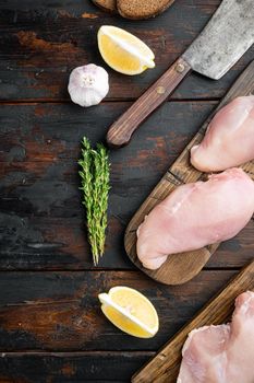 Raw crumbet chicken fillet with ingredient, on dark wooden background, top view with copy space