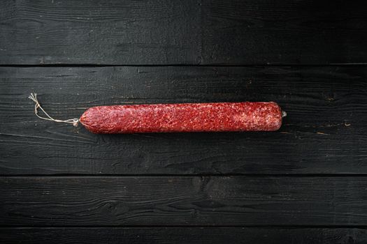 Fresh baked sausage Salami set, on black wooden table background, top view flat lay, with copy space for text