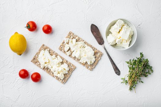Fresh rye crispbreads with different topping set, on white stone table background, top view flat lay, with copy space for text