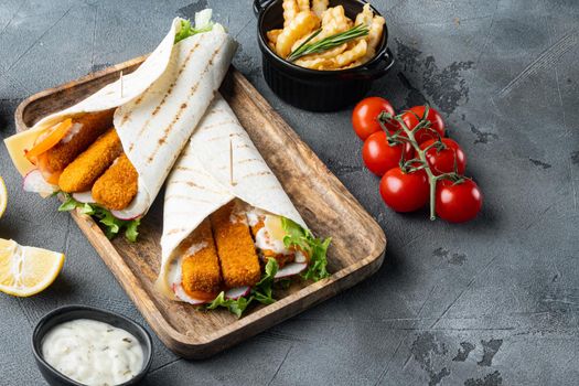 Fish fingers roll and tartar sauce set, on wooden tray, on gray background , with copyspace and space for text