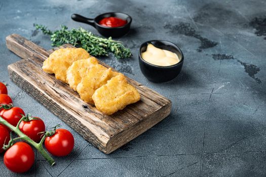 Chicken nuggets fried on grey background, with space for text.