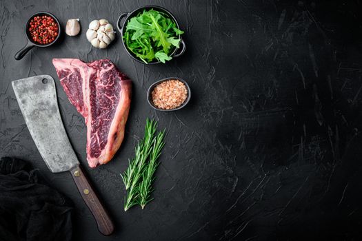 Thick Raw T-Bone Steak with Seasoning and Rosemary set, on black stone background, top view flat lay, with copy space for text