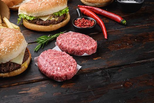 Beef meat steak cutlets for burger on wooden table with copy space.