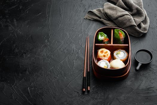 Japanese bento lunch box with chopsticks set, on black stone background , with copyspace and space for text