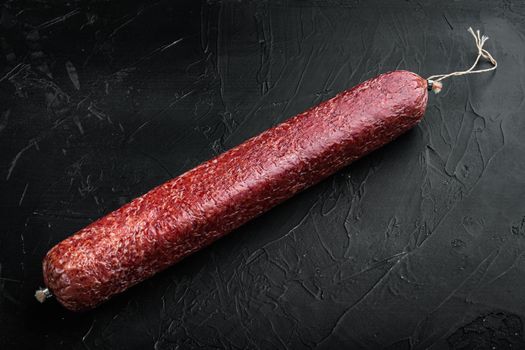 Beef Salami Sausage set, on black dark stone background, with copy space for text