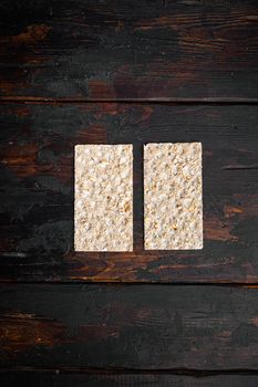 Crispbread with sunflower, chia and sesames seeds set, on old dark wooden table background, top view flat lay, with copy space for text