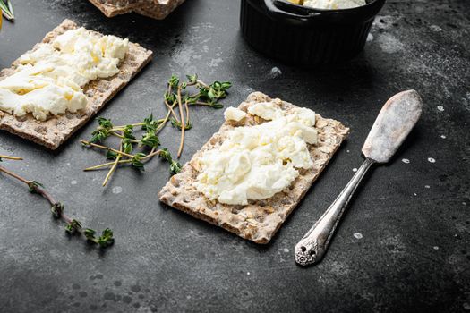 Homemade Crisp bread toast with Cottage Cheese set, on black dark stone table background, with copy space for text