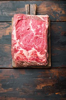 Veiny steak, marbled beef raw meat, on dark wooden background, top view