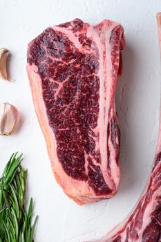 Dry Aged club raw steak set, on white stone background, top view flat lay