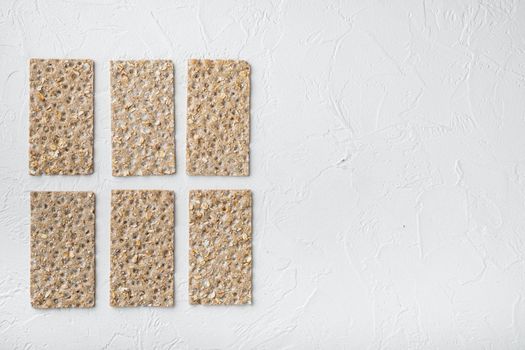 Wholegrain Rye Crispbread cracker set, on white stone table background, top view flat lay, with copy space for text