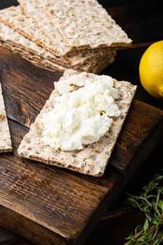 Homemade Crisp bread toast with Cottage Cheese set, on old dark wooden table background