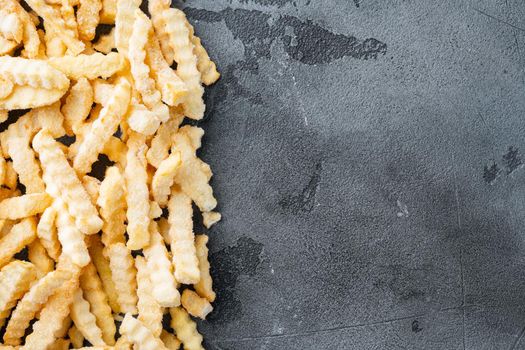 Frozen crinkle oven fries set, on gray background, top view flat lay , with copyspace and space for text