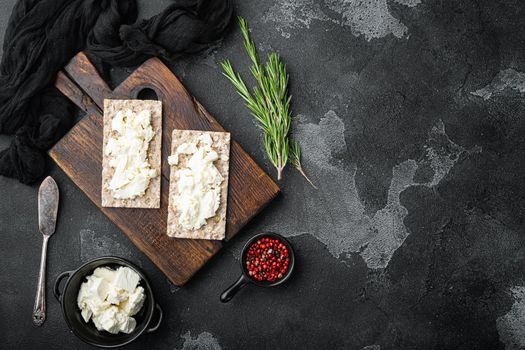 Homemade Crisp bread toast with Cottage Cheese set, on black dark stone table background, top view flat lay, with copy space for text
