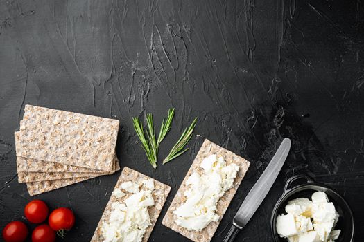 Crisp bread sandwich set, on black dark stone table background, top view flat lay, with copy space for text
