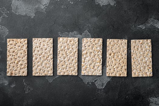 Crunchy crispbread Healthy snack set, on black dark stone table background, top view flat lay, with copy space for text
