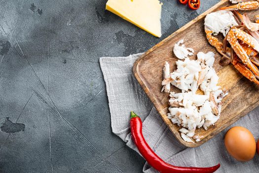 Ingredients for breakfast omelette with crab meat and cheese set, on gray background, top view flat lay , with copyspace and space for text