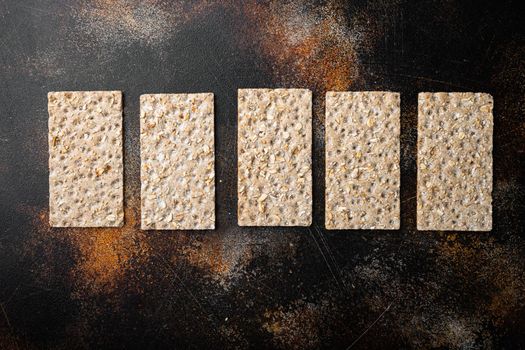 Grain diet light crisp bread set, on old dark rustic table background, top view flat lay, with copy space for text