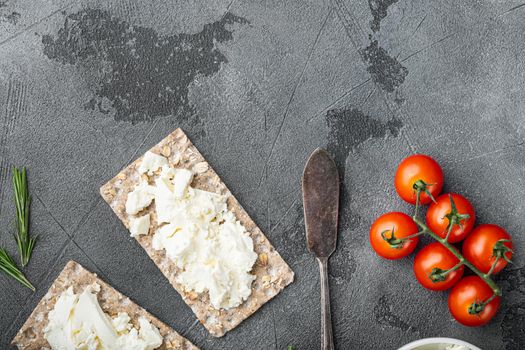 Curd sandwiches with fresh herbs. Crispbread toast with cottage cheese set, on gray stone table background, top view flat lay, with copy space for text