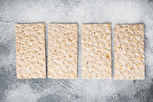 Set of crispy breads set, on gray stone table background, top view flat lay, with copy space for text