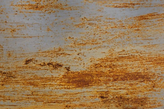 rusted flat solid sheet metal background and texture with leftovers of white paint, vertical crop
