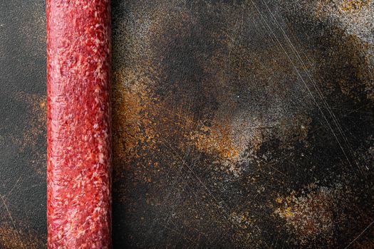 Traditional smoked salami sausage set, on old dark rustic background, top view flat lay, with copy space for text