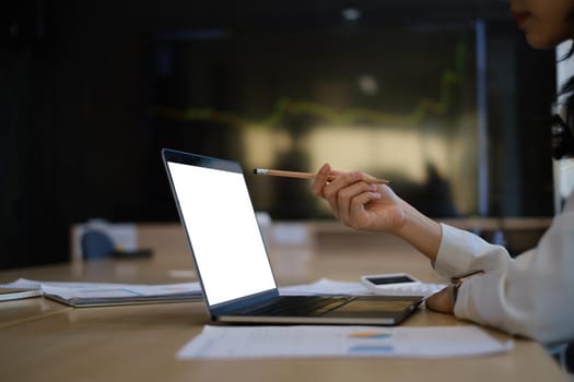 Business woman trader investor using laptop with cryptocurrency stock market graph on background. stock chart, investment concept