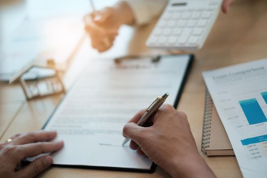 After a discussion in a exclusive room at the corporate , a businessman and his partner sign a contract investment professional paper agreement