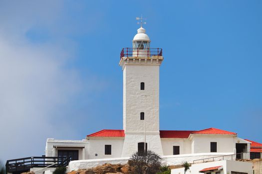 Bright white lighthouse building and tower at Cape Saint Blaize lighthouse complex, Mossel Bay, South Africa