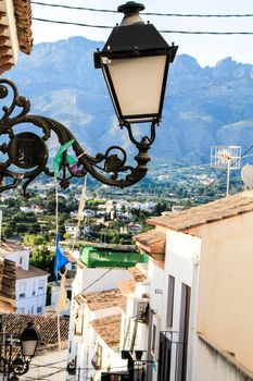 Narrow streets and beautiful whitewashed facades with vintage streetlight in Altea village, Alicante, Spain