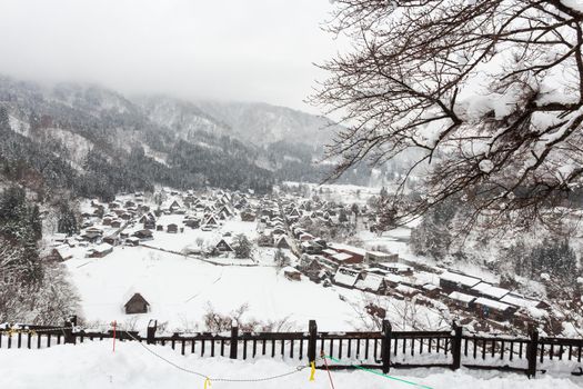 Shirakawago village with snow fall in winter season . Landmark of Gifu , Takayama , Japan . View point landscape .