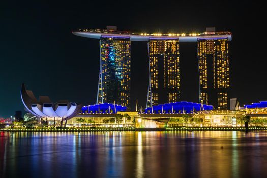 Singapore skyline cityscape around marina bay at night .